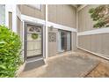 Close-up of the front entrance with decorative wreath, sliding glass door, and concrete patio at 664 Powers Ferry North Se, Marietta, GA 30067