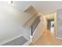 Bright hallway featuring wood floors, a carpeted staircase, and access to other rooms at 664 Powers Ferry North Se, Marietta, GA 30067