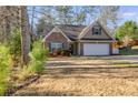 Charming brick home with a well-maintained front yard and attached two-car garage at 8166 N Pine Cone Dr, Villa Rica, GA 30180