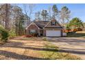 Charming brick home with a well-maintained front yard and attached two-car garage at 8166 N Pine Cone Dr, Villa Rica, GA 30180