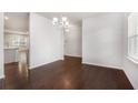 Bright dining area featuring hardwood floors and a modern chandelier fixture at 400 Paulownia Cir, Mcdonough, GA 30253