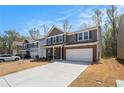 This stunning two-story home features a well-maintained lawn and a spacious driveway leading to an attached garage at 400 Paulownia Cir, Mcdonough, GA 30253