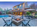 Luxurious backyard featuring a multi-level deck, outdoor seating, fire pit, and a sparkling swimming pool at 1438 Kings Park Nw Dr, Kennesaw, GA 30152