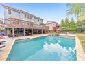 Stunning backyard pool with a spa, sun loungers, and outdoor seating area at 1438 Kings Park Nw Dr, Kennesaw, GA 30152