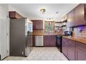 Charming kitchen features stainless steel appliances, hexagon tile floor, and modern countertops at 3650 Dogwood Farm Rd, Decatur, GA 30034