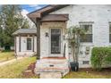 Close up on front door with 'R' on it and small porch and adjacent smaller structure at 1780 John Calvin Ave, Atlanta, GA 30337