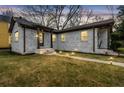 Charming white brick home with inviting walkway lighting and well-maintained lawn at dusk at 1780 John Calvin Ave, Atlanta, GA 30337