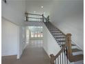 Spacious entryway with soaring ceilings, wood floors, and staircase leading to second floor landing at 2155 Suncrest Point, Marietta, GA 30064