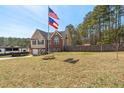 A well-maintained front yard and two story home, with a flag and a charming deck at 248 Christian Circle, Carrollton, GA 30116
