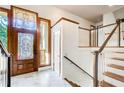 Foyer featuring decorative glass in the front door and stairway with glass panels at 4983 Odins Way, Marietta, GA 30068