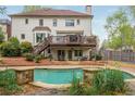 Enjoy the private backyard oasis featuring a sparkling pool, stone accents, and a spacious deck perfect for entertaining at 730 Denmead Se Ml, Marietta, GA 30067