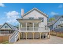 Back of house view showcasing an elevated porch and stairs leading to the backyard and driveway at 3055 Alston Dr, Decatur, GA 30032