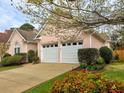 Charming single-story home featuring a well-manicured lawn, a two-car garage, and a welcoming entrance at 4103 Christacy Way, Marietta, GA 30066