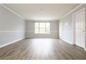 Bright living room with wood-look floors and freshly painted gray walls and white trim at 225 Bentley Pl, Tucker, GA 30084