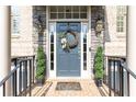Inviting front entrance with brick accents, decorative wreath, and elegant outdoor lighting at 3110 Dickson Ne St, Brookhaven, GA 30319