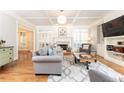 Bright living room with coffered ceilings, a fireplace, hardwood floors and custom built-ins at 3110 Dickson Ne St, Brookhaven, GA 30319