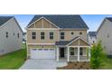 Classic two-story home with neutral siding, a covered front porch, and an attached two-car garage at 13562 Whitman Ln, Covington, GA 30014