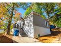 Well-kept home featuring gray siding, easy access stairs and a nicely landscaped yard at 7024 Evergreen Way, Buford, GA 30518