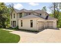 Stylish home with a two-car garage, beautiful landscaping, and a well-maintained yard at 1068 Moores Mill Nw Rd, Atlanta, GA 30327
