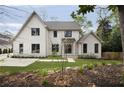 Two-story home with white brick, complemented by well-kept lawn and landscape at 1074 Moores Mill Nw Rd, Atlanta, GA 30327