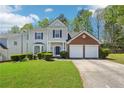 Charming two-story home with a well-manicured lawn, two-car garage, and complementary landscaping at 3936 Toccoa Falls Dr, Duluth, GA 30097