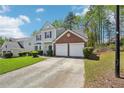 Traditional two-story home featuring well-kept landscaping, a driveway, and an attached two-car garage at 3936 Toccoa Falls Dr, Duluth, GA 30097