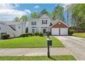 Inviting two-story home with a verdant lawn and a mailbox, blending classic charm with modern living at 3936 Toccoa Falls Dr, Duluth, GA 30097