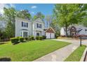 Well-maintained two-story residence with a two-car garage, green lawn, and inviting facade at 3936 Toccoa Falls Dr, Duluth, GA 30097