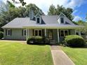 Charming single-Gathering home with a well-manicured lawn and covered front porch at 728 Slew Ave, Lawrenceville, GA 30043