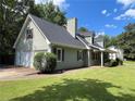 Beautiful home with attached garage, lush lawn, and mature landscaping at 728 Slew Ave, Lawrenceville, GA 30043