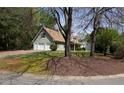 Home featuring an attached garage, neutral siding, and a green front yard at 728 Slew Ave, Lawrenceville, GA 30043