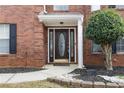 Elegant front door with decorative glass and sidelights, complemented by brick facade and landscaping at 130 Arbor Cove Way, Stockbridge, GA 30281