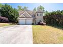 Two-story home with two-car garage, front yard with a mature tree at 3986 Harmony Walk Se Way, Smyrna, GA 30082
