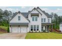 Charming white brick home with lush green lawn and a two car garage with inviting curb appeal at 1011 Ridgeview Rd, Woodstock, GA 30188