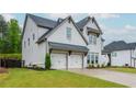 Well maintained two-story white brick home with a two car garage, green lawn, and landscaping at 1011 Ridgeview Rd, Woodstock, GA 30188