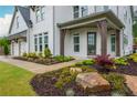 Well-manicured front yard with beautifully landscaped flower beds, rock features, and a brick and wood home at 1011 Ridgeview Rd, Woodstock, GA 30188
