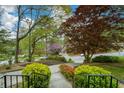View from the porch of a well-maintained front yard with mature trees and flowering bushes at 1245 Briar Hills Ne Dr, Atlanta, GA 30306