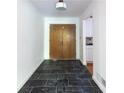 The home's foyer features dark-tiled floors, neutral paint, and a light fixture at 558 Larchmont Nw Dr, Atlanta, GA 30318