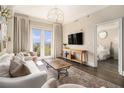 Cozy living room with balcony, modern TV, and open view to bedroom at 2277 Peachtree Rd # 503, Atlanta, GA 30309