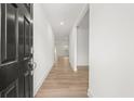 Inviting entryway with light wood floors, white walls and a dark front door, creating a bright and modern entrance at 2831 Centerville Rosebud Rd, Snellville, GA 30039
