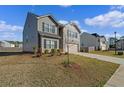 Side view of the two-story house, featuring lawn and driveway at 3038 Chris Cir, Villa Rica, GA 30180