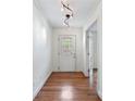 Inviting foyer with hardwood floors, modern lighting, and a glass-paneled front door at 3200 W Roxboro Rd, Atlanta, GA 30324