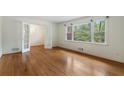 Bright living room with hardwood floors, white walls, and large windows offering ample natural light at 3200 W Roxboro Rd, Atlanta, GA 30324