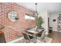 Inviting dining room area with brick accent wall, pendant lighting, seating for four, and stylish decor at 19 Ne Rumson Ne Rd # B20, Atlanta, GA 30305