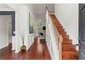 Bright, two-story foyer featuring hardwood floors, white wainscoting, and an open staircase at 2015 Chelton Se Way, Smyrna, GA 30080