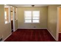 Cozy living room with plush red carpet, classic trim, and natural light at 130 Scarlet Dr, Jonesboro, GA 30236