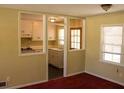 Bright living room with classic trim and large windows showcasing an eat-in kitchen at 130 Scarlet Dr, Jonesboro, GA 30236