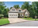 Inviting home with stone and white siding, an attached garage, and beautiful landscaping with a well-maintained lawn at 244 Cedar Ridge Way, Dallas, GA 30157