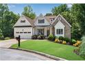 Charming home with stone and white facade and a well maintained lawn with colorful flower beds for extra curb appeal at 244 Cedar Ridge Way, Dallas, GA 30157