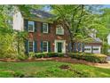 Lovely brick home with blue shutters, well-maintained landscaping, and a welcoming front entrance at 1550 Pine Creek Way, Woodstock, GA 30188
